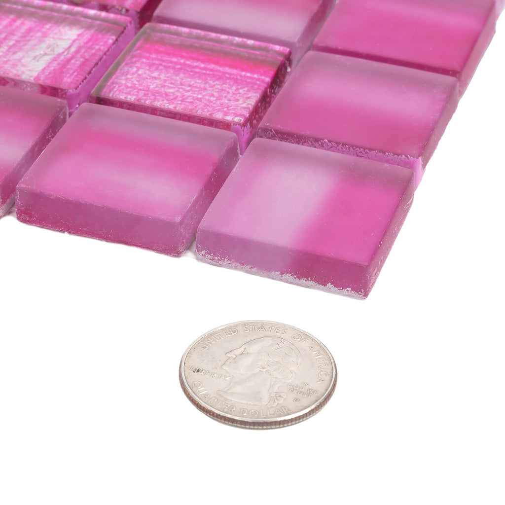 close-up of fuchsia pink glossy and matte glass mosaic tiles with varying textures