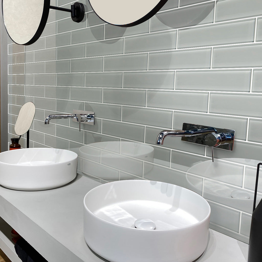 glossy gray 3x12 glass subway tile installed in horizontal layout with clean grout lines