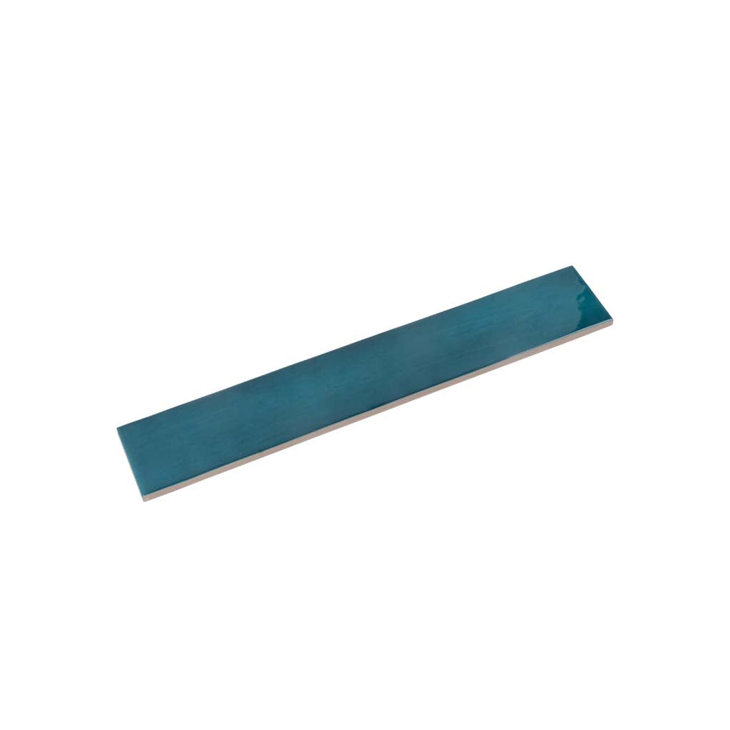 Glossy teal green ceramic subway tile measuring 2.6 by 16 inches with smooth finish