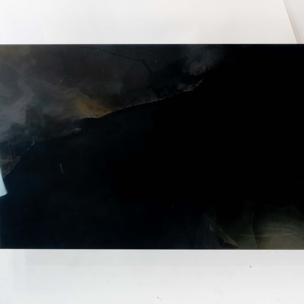 black 24x48 lappato porcelain large tile with subtle gray veining and high gloss finish