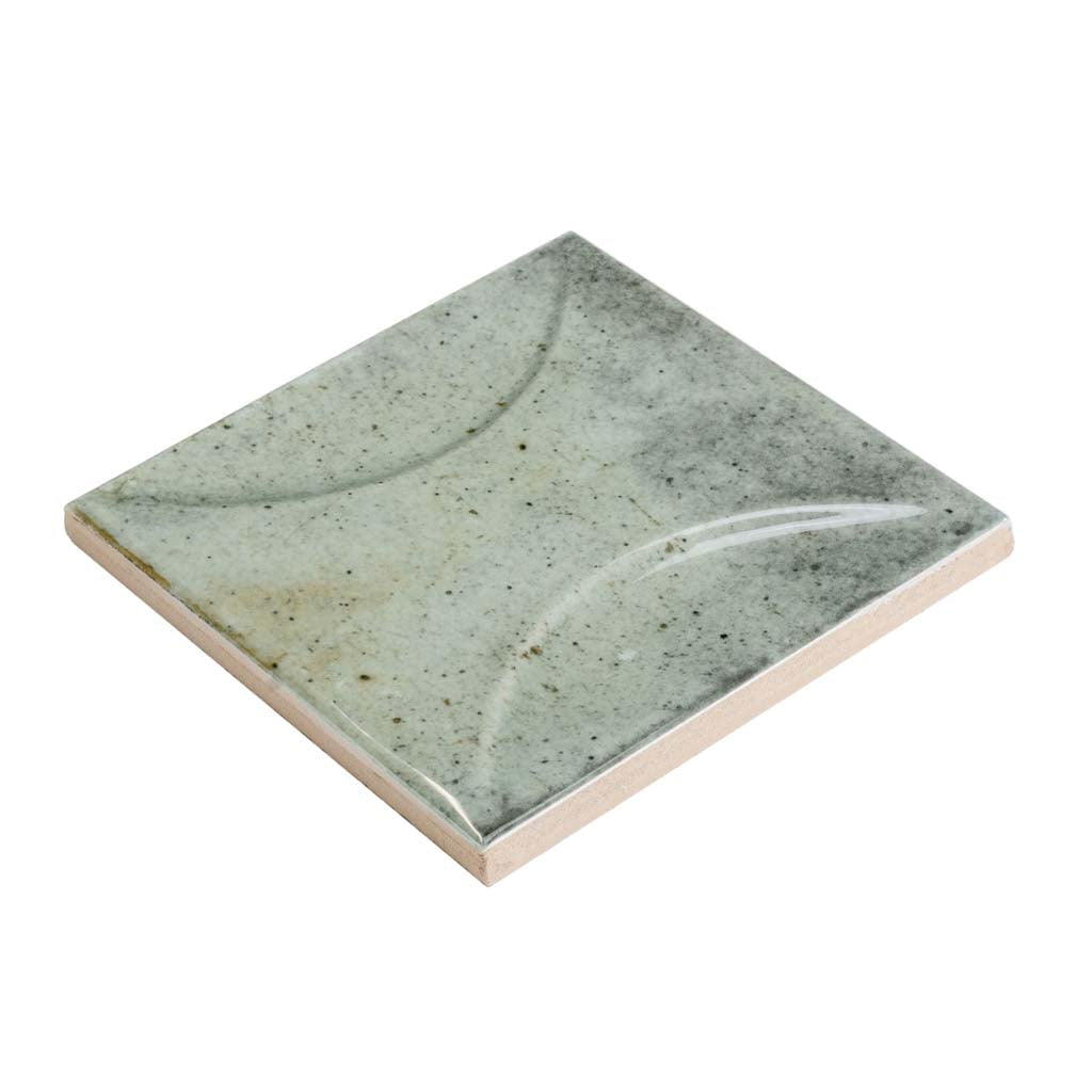 Glossy sage green 4x4 ceramic subway deco tile with subtle pattern and textured finish