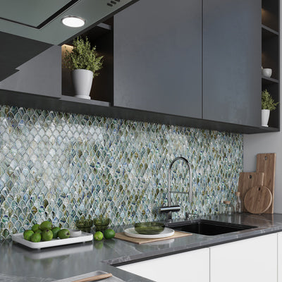 blue and silver glossy glass mosaic tile backsplash with fish scale pattern in kitchen