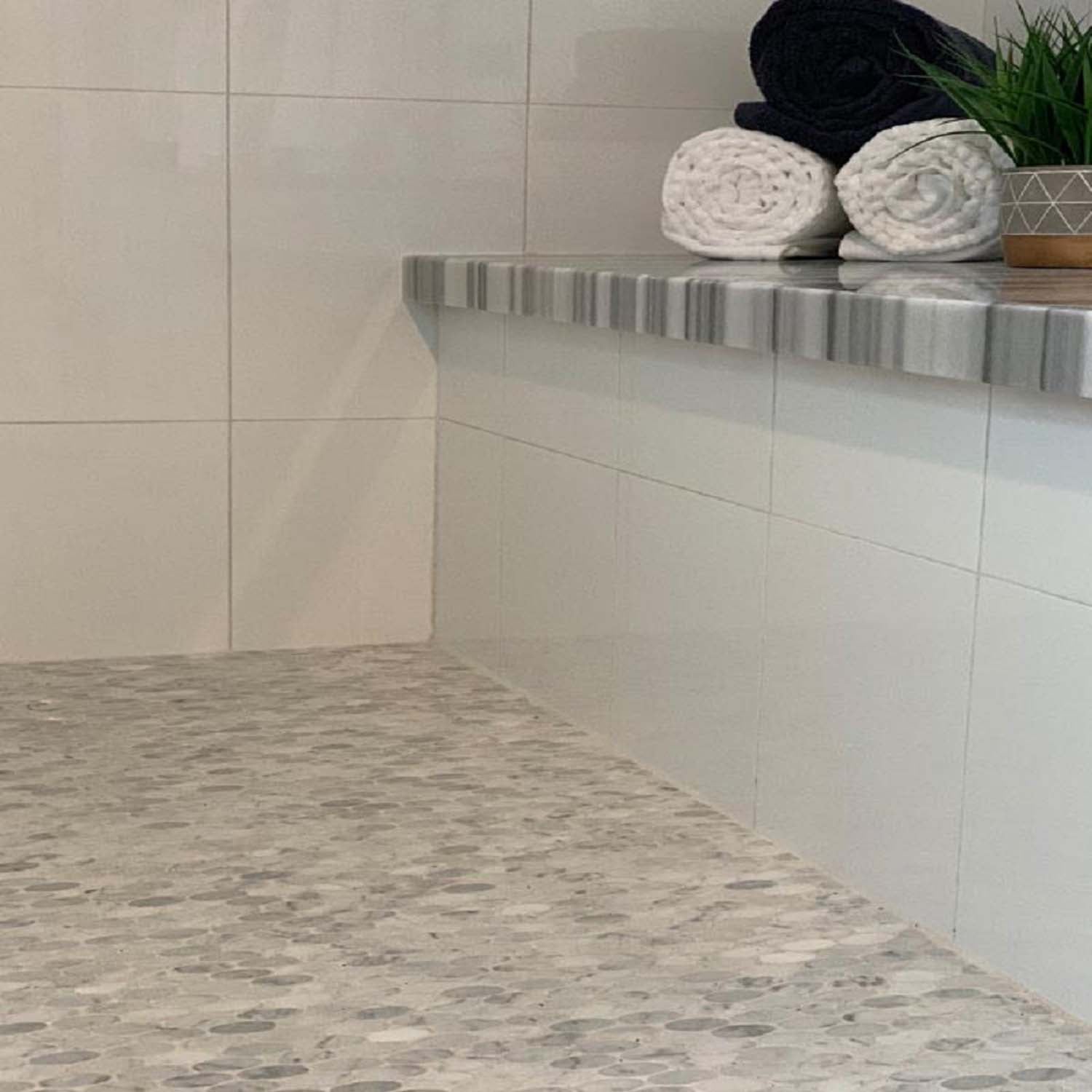 white polished ellipse bianco carrara marble mosaic tile wall and floor setting
